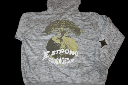 Gray jacket with a tree graphic and puff print 'Be Strong Be Courageous' text .